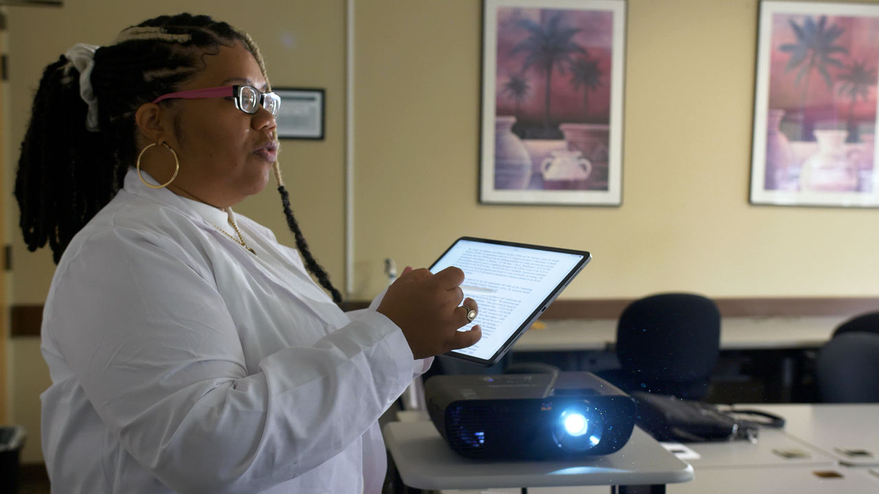 Scientist presenting research with digital tablet